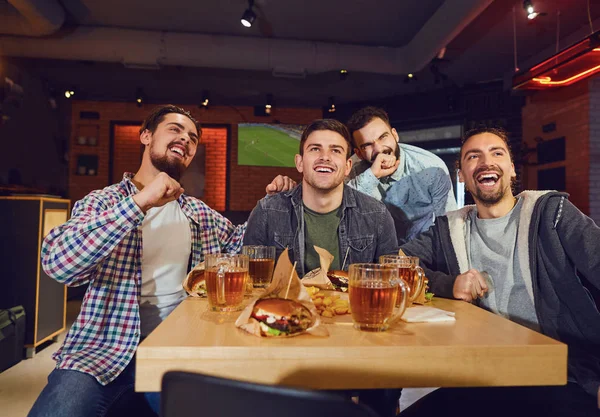 Amigos fans ver deporte tv en el pub — Foto de Stock