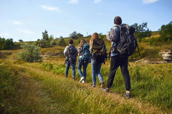 Um grupo de turistas com mochilas está andando na natureza — Fotografia de Stock