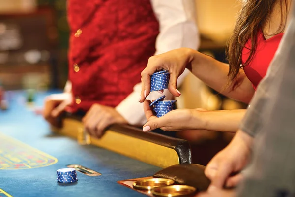 Hands with chips at poker roulette table gambling in a casino. — Stock Photo, Image