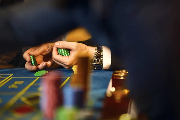 Chips in the hands of a player in a casino.