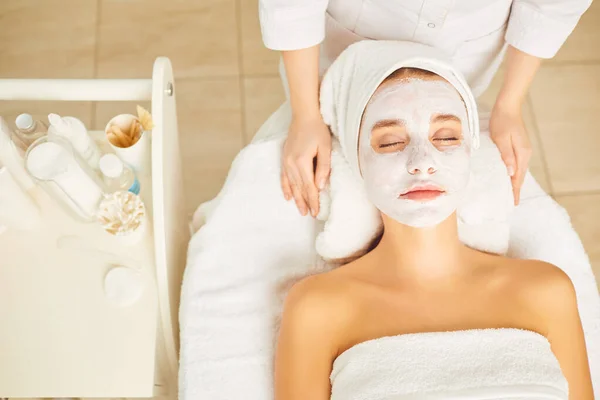 Spa salonunda bir kadının yüzünde kozmetik maske. — Stok fotoğraf