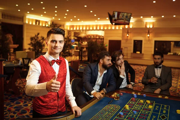 クルーピエはカジノのポーカールーレットで働く. — ストック写真