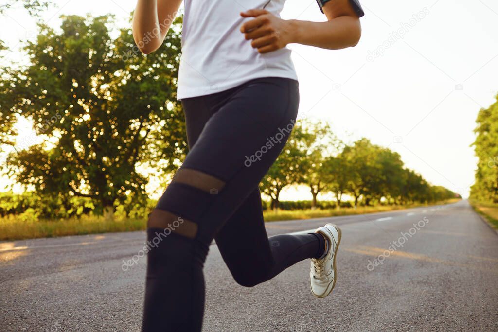 One young fitness girl runner running road