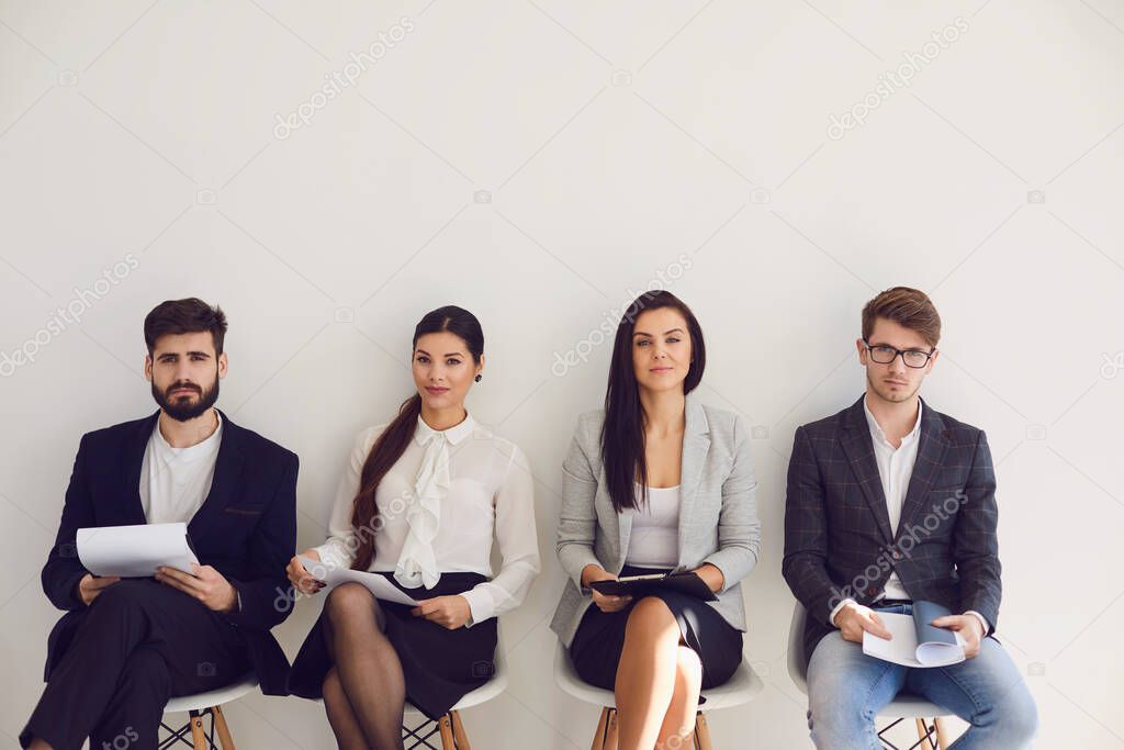 Business people waiting for job interview recruitment sitting on a chair in the office.