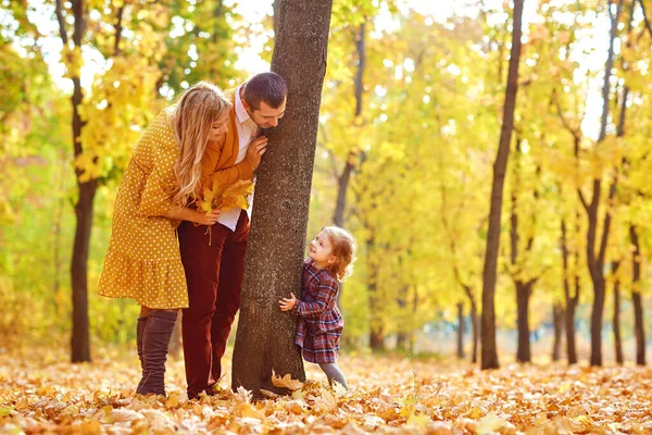 Parents with the daughter play in park in the fall — Stock Photo, Image