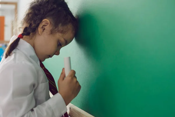 Escolar triste en la pizarra en el aula. Problemas de estrés con las matemáticas en un niño — Foto de Stock