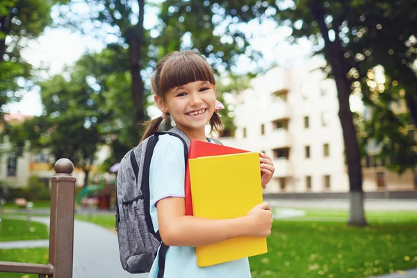 Bonne petite étudiante avec un sac à dos sur le chemin de l'école. — Photo