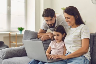 Bilgisayarlı aile. Ebeveynler ve kızları doktorlara danışırlar ve evde görüntülü sohbet bilgisayarları vardır.
