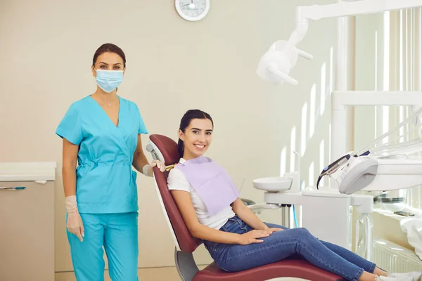 Portrait of a happy woman and her dentist after dental examination and dental treatment. — Stock Photo, Image
