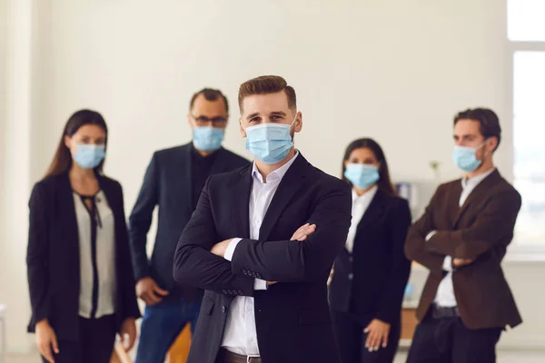 Company manager and employees care about clients and colleagues wearing face masks at work