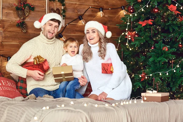 Eltern und Sohn lachen am Ende des Weihnachtsbaums — Stockfoto