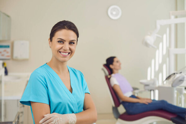 Female dentist in a dental office on the background of dental accessories.