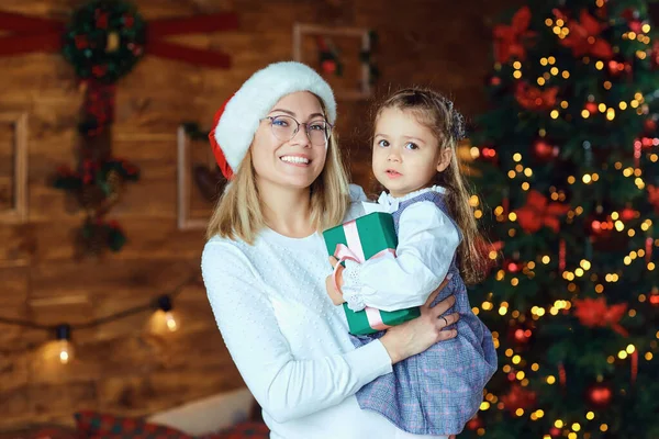Mom with her daughter with gifts at Christmas. — Stock Photo, Image