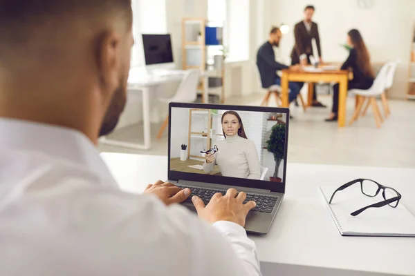 Company worker sitting in office and having online meeting with director, client, coach or colleague — Stock Photo, Image