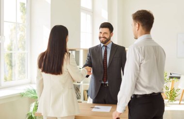 Office confident diverse business people, men and woman shaking hands in office, smiling, customer giving handshake to manager, lawyer, ending meeting, negotiation, deal, startup collaboration