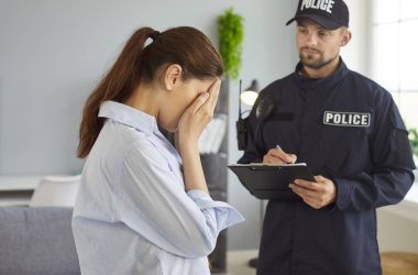 Woman cries during conversation with police officer, aiding investigate crime, supporting victim, assisting detective on burglary, conducting law interview in a tense professional setting.