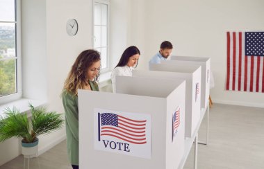 Voters in booths, young active people on Election Day polling station, happy Americans marking ballot paper choosing candidate for political position, official job, process of electing in USA