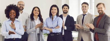 Group portrait of a diverse and multiracial community of professional business people in the office. This team represents a company committed to inclusivity and collaboration in the workplace.