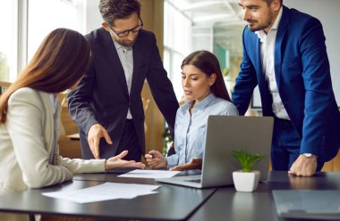 Bir grup iş adamı ya da şirket çalışanı çalışma masasında oturup bir şeyler tartışıyor, anlaşmaya varıyor ve bir sözleşme imzalıyor. İş arkadaşları ofiste toplantı yapıyor..