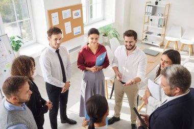 Group of business professional people communicating during a meeting in the office. Team engage in teamwork, collaboration, and discussions to achieve shared goals in a productive work environment.