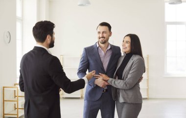 Family couple inspects new home with realtor or estate agent, considering property or apartment rent or purchase, collaborative process in a home environment tailored to housing decisions.