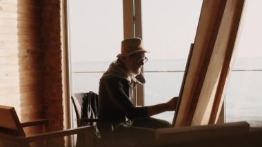 Eldery sanatçı bir resim çizim.