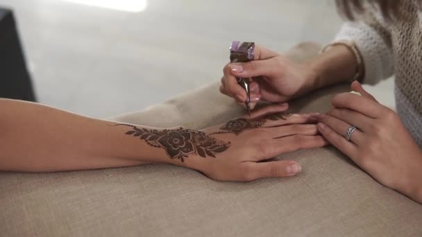 Applying henna on hands.