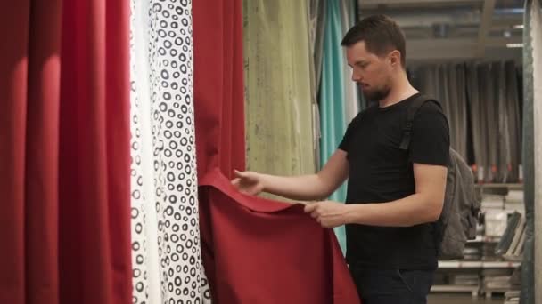 Man checking new curtains. — Stock Video