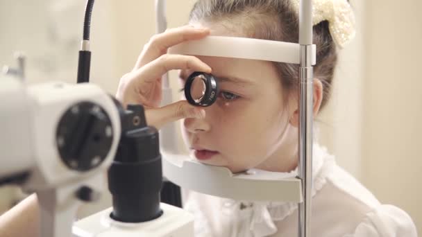 Portrait of girl who checks her eyesight with an ophthalmologist in a polyclinic — Stock Video