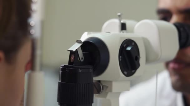 Female patient on a procedure of biomicroscopy of eye, close-up — Stock Video