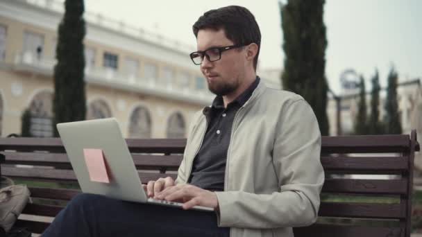 Adult graduate student writes a thesis for university studies on a laptop — Stock Video
