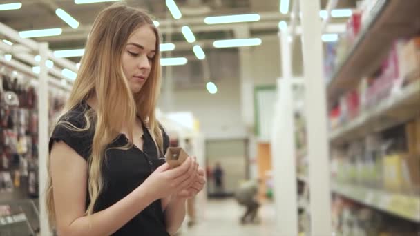 Mujer joven comprando bombilla eléctrica . — Vídeos de Stock
