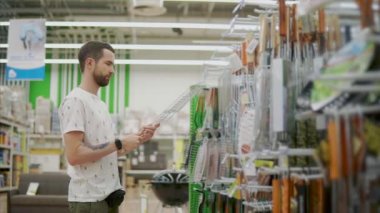 Erkek müşteri bir dükkanda Barbekü için Grid alıyor ve kontrol