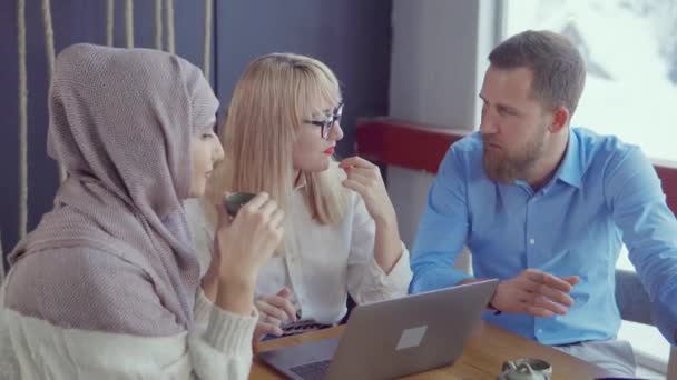 Three male and female business partners are communicating and drinking tea — Stock Video