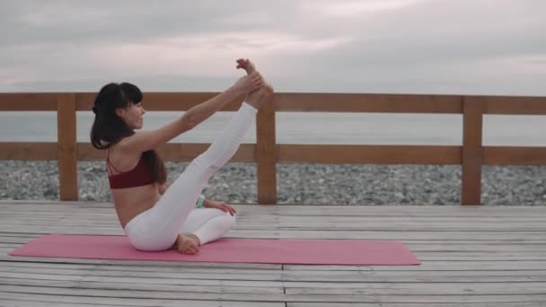 Mujer calentando al aire libre en la playa . — Vídeo de stock