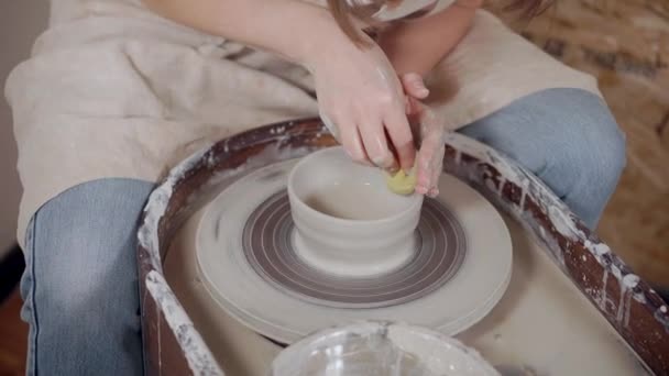 Woman is working in pottery, using potter wheel, close-up — 비디오