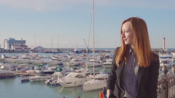 Kvinna går på stor balkong och tittar på stadens hamn på havet — Stockvideo