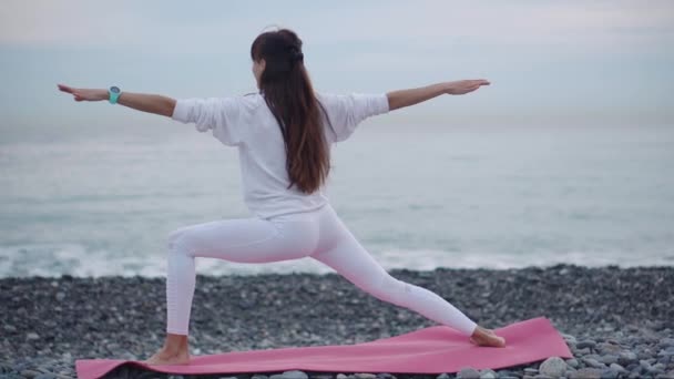 Yoga practice on sea shore. — Stock Video