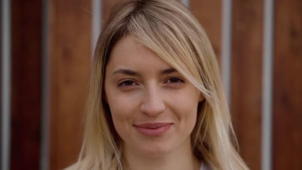 Close-up portrait of young joyful woman, looking at camera on street — Stock Video