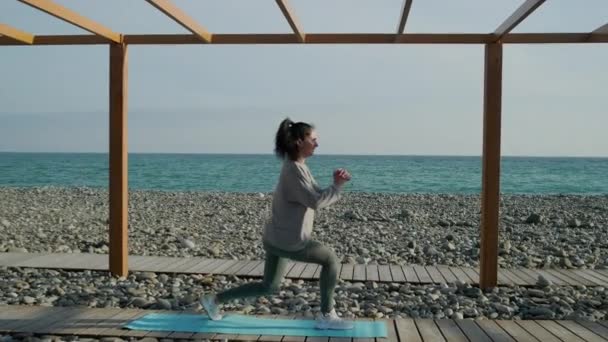 Ragazza exrcising all'aperto sulla riva del mare . — Video Stock