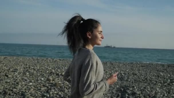 Fitness femme courant le soir sur la plage . — Video