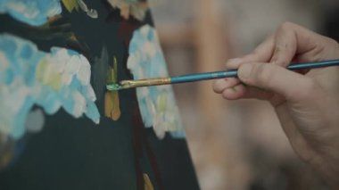 Ressam akrilik boya ile resim çiziyor