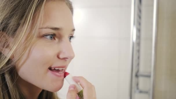 Frau bemalt Lippen mit Lippenstift — Stockvideo