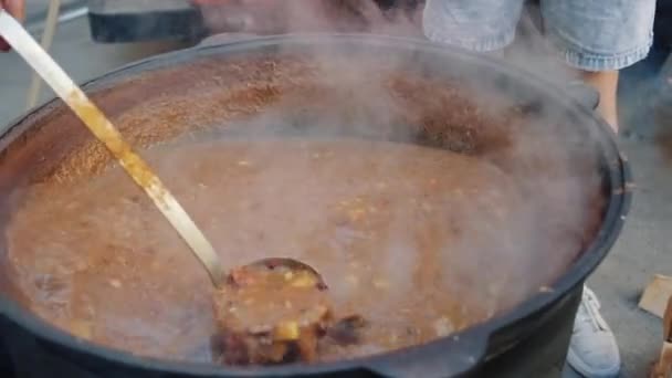 Chef is stirring soup goulash in large pot — Stock Footage Chef is stirring soup goulash in large pot Video Clip