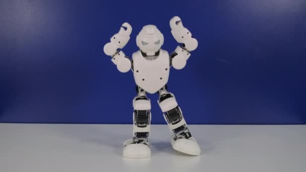 Pequeño robot humano hace movimientos de baile en el stand — Vídeo de stock