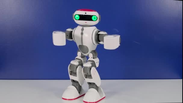 Small funny robot toy moves hands changing pose — Stock Video