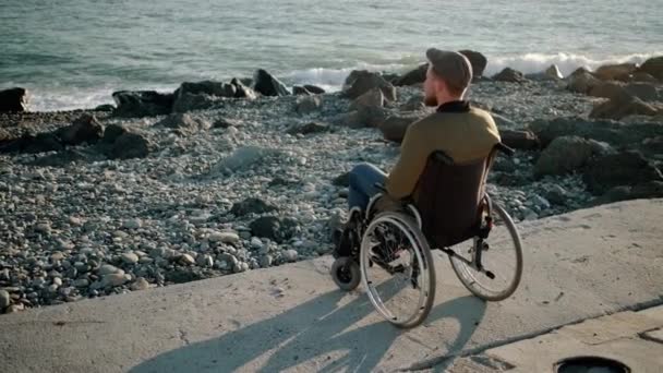 Einsamer behinderter Mann starrt aufs Meer — Stockvideo
