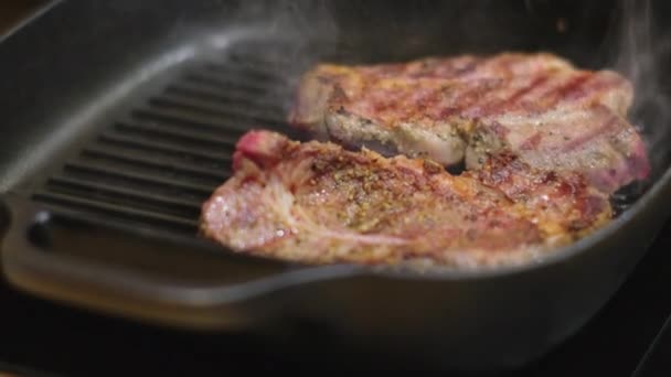 Geroosterde steaks bij de koekenpan in de thuiskeuken — Stockvideo