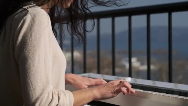 Hands of a woman pianist moving slowly by musical keyboard — Stock Video