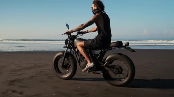 Reiziger is paardrijden motor over zee strand — Stockvideo